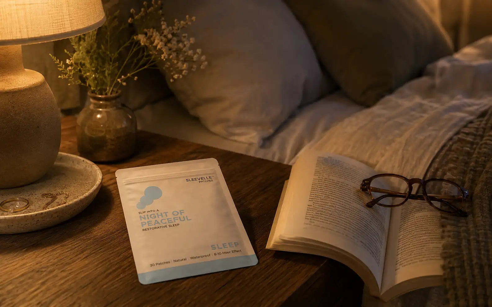 Sleevelle patch pouch on a nightstand by a lamp